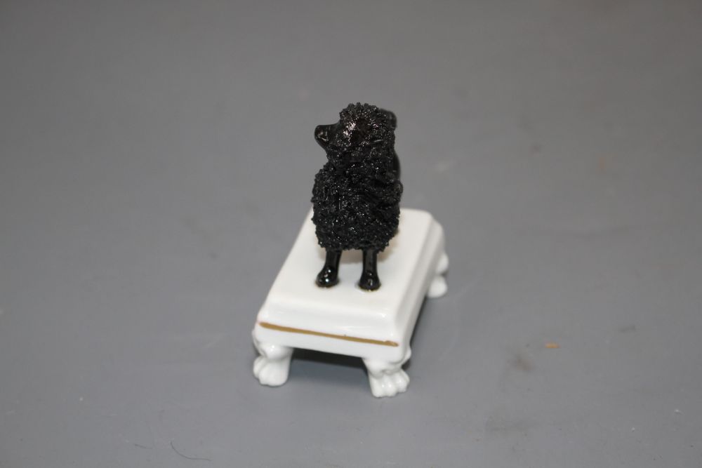 A rare Staffordshire small porcelain figure of a black poodle, c.1830-50, H. 7.5cm